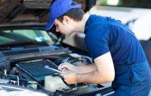 Smiling car mechanic at work